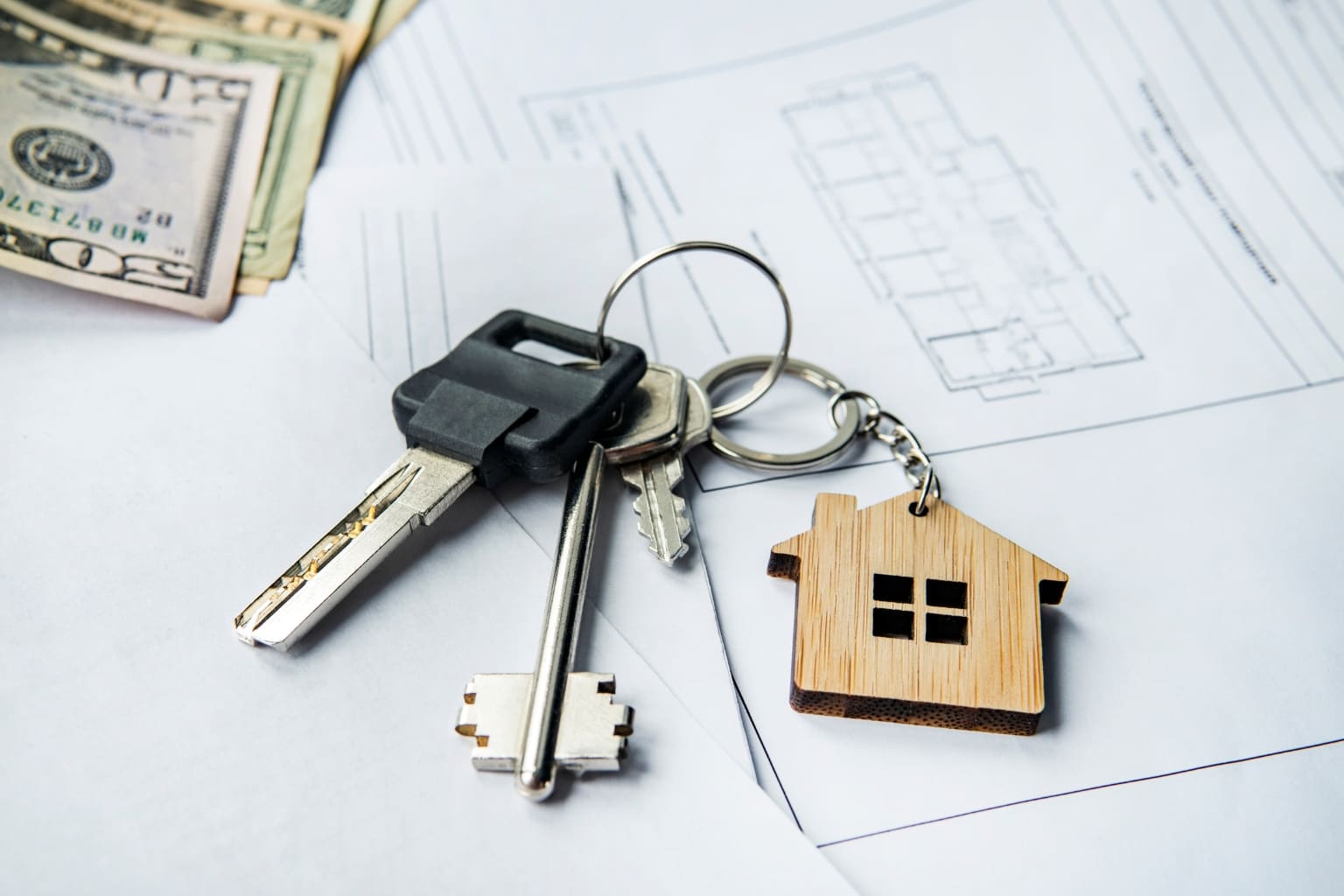 Cash Buyers in the Bay Area real estate documents, house keys, and cash on the table | Cash Buyers in the Bay Area