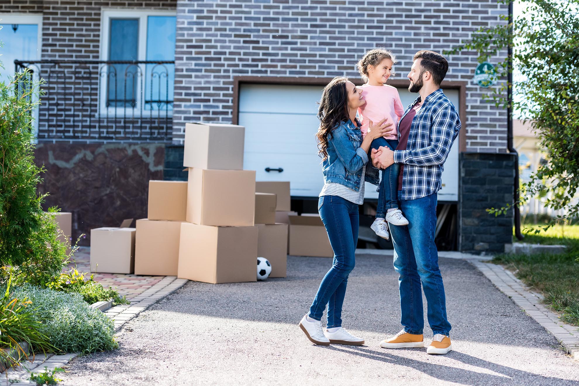 family in front of new house