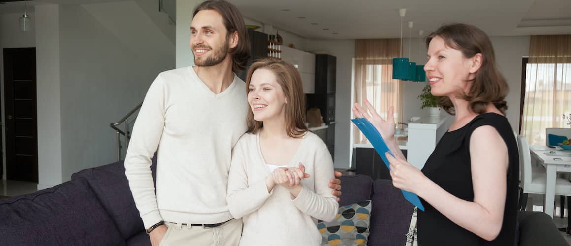 Stock-Young-Couple-In-White-Shirts-With-Agent-In-Living-Room-AdobeStock232826569 copy