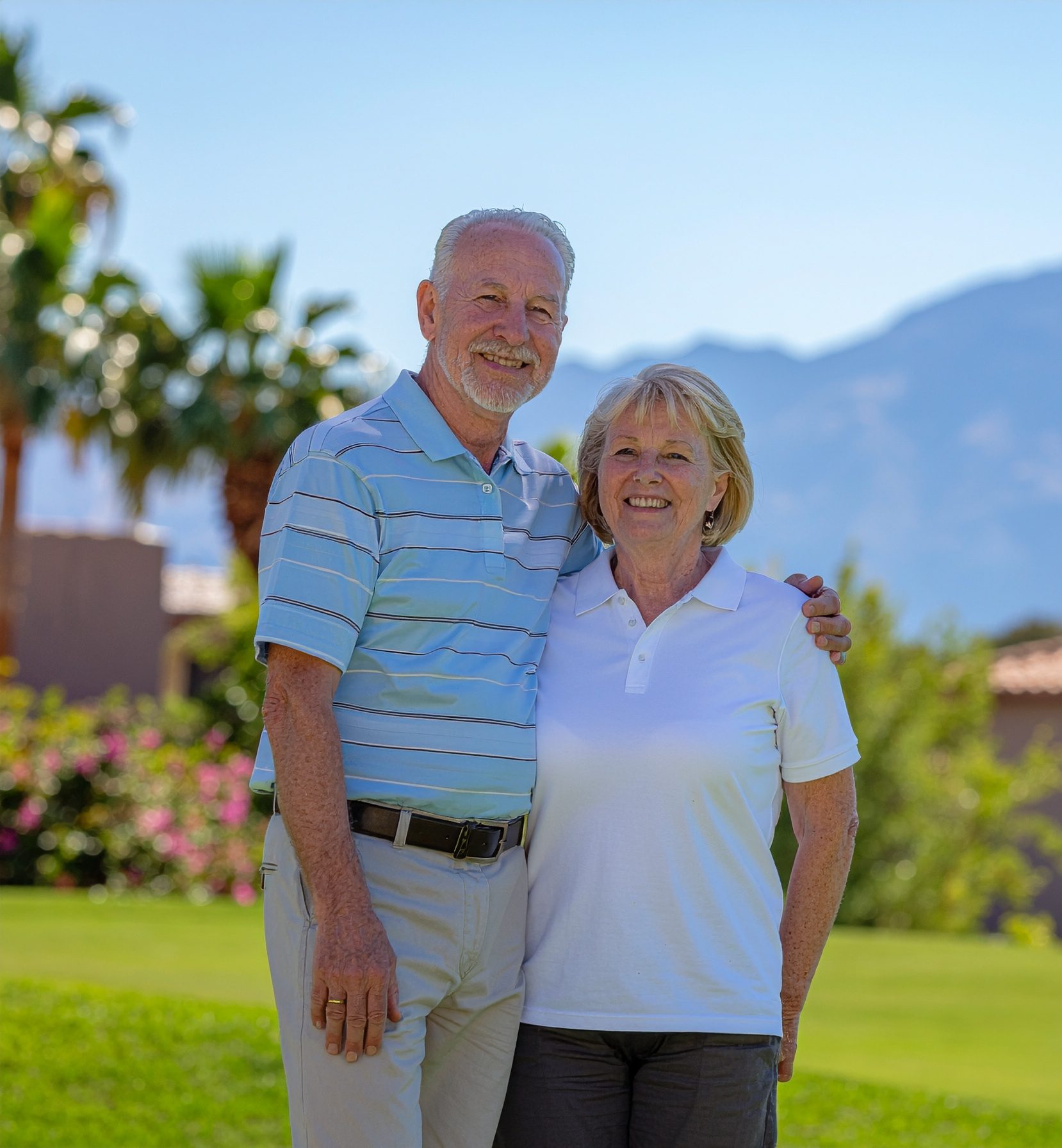 senior couple on golf course in arizona with palm trees