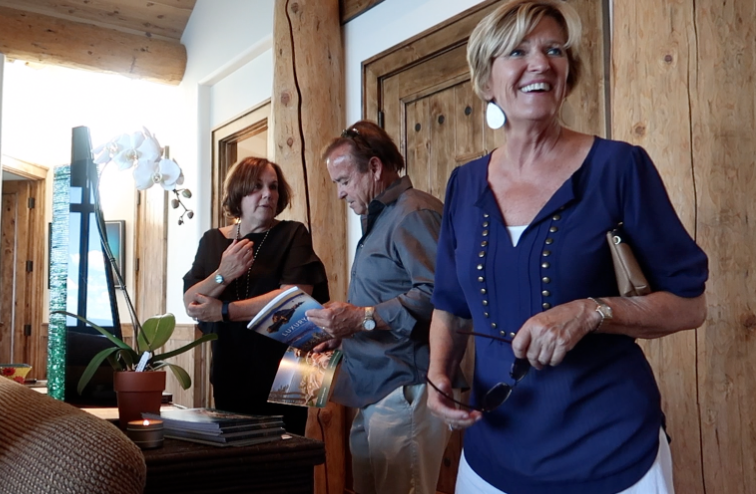 Sue Lowe with guests welcoming them to South Peak Lodge, a stunning home with outstanding views of Lake Tahoe.
