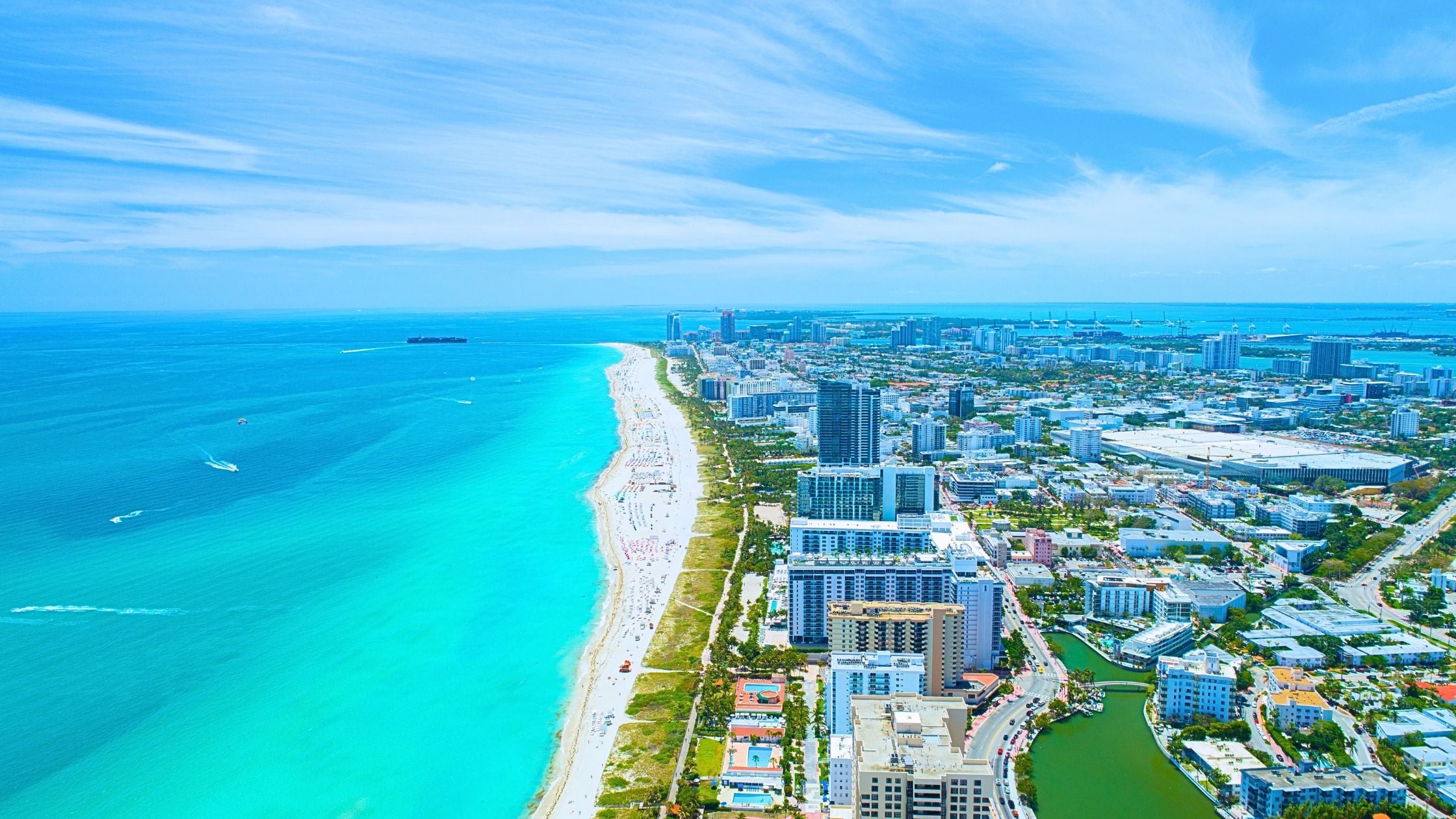 Aerial view of Miami Beach coastline with turquoise water and oceanfront condos
