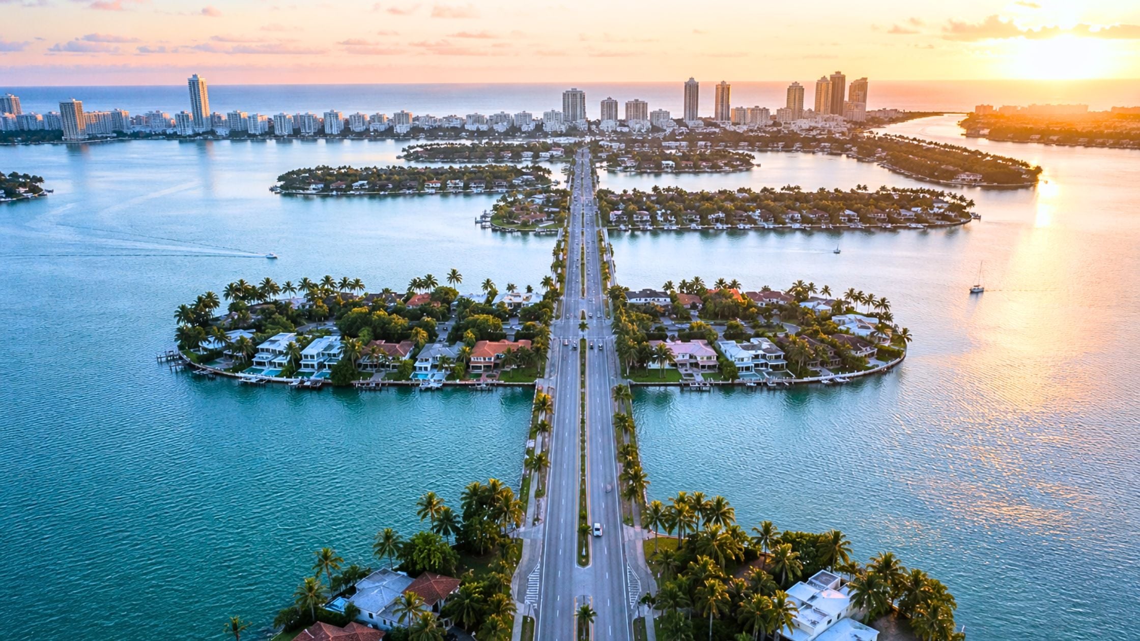 Aerial view of Venetian Causeway Miami looking east toward Miami Beach at sunrise with Biscayne Bay on both sides