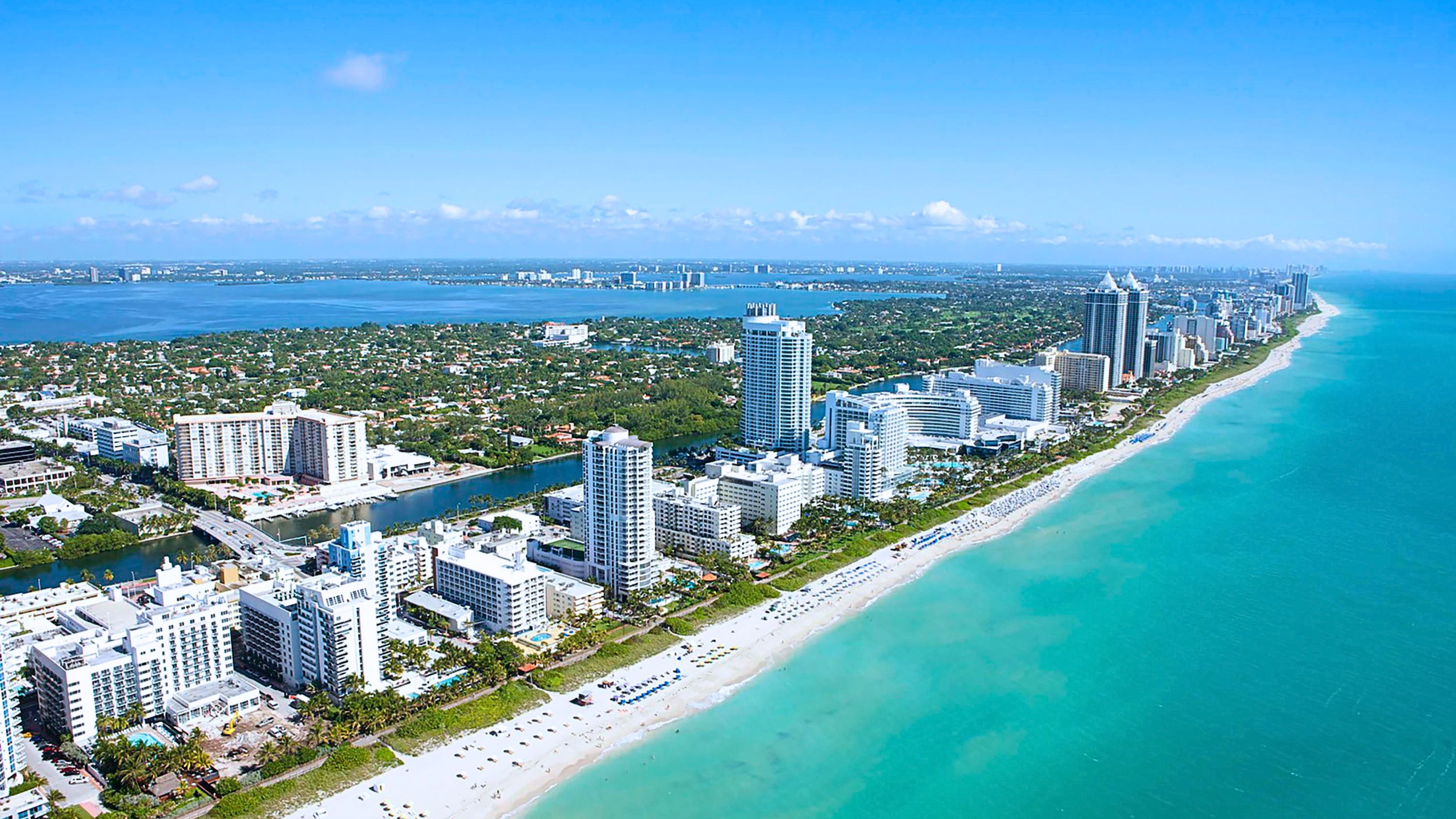 Sunny Isles Beach oceanfront luxury condo towers at golden hour representing living in Sunny Isles Beach