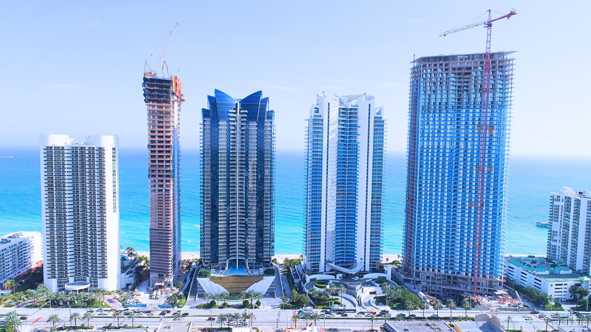 Miami new construction skyline with cranes and high-rise condo towers representing the 2026 development cycle