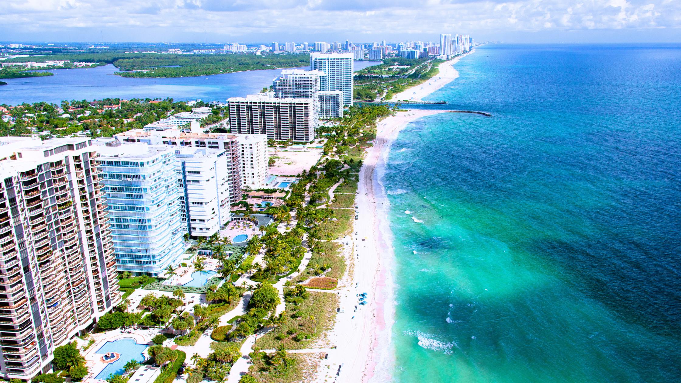 Oceanfront condo buildings along the beach in Surfside Florida, key market for selling a home in Surfside