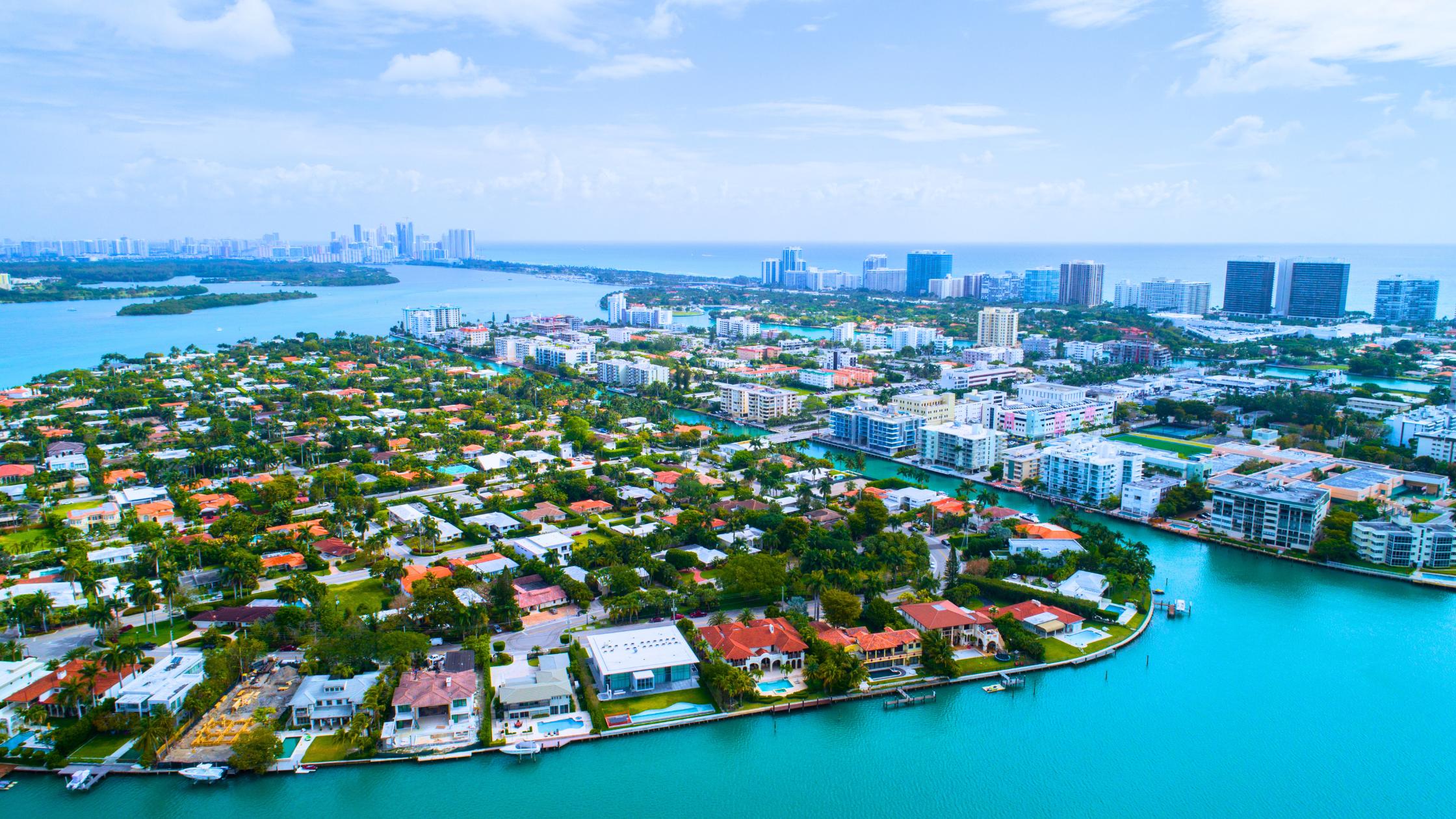 Aerial view of Bay Harbor Islands single-family homes with canals and Biscayne Bay in the background, Miami.