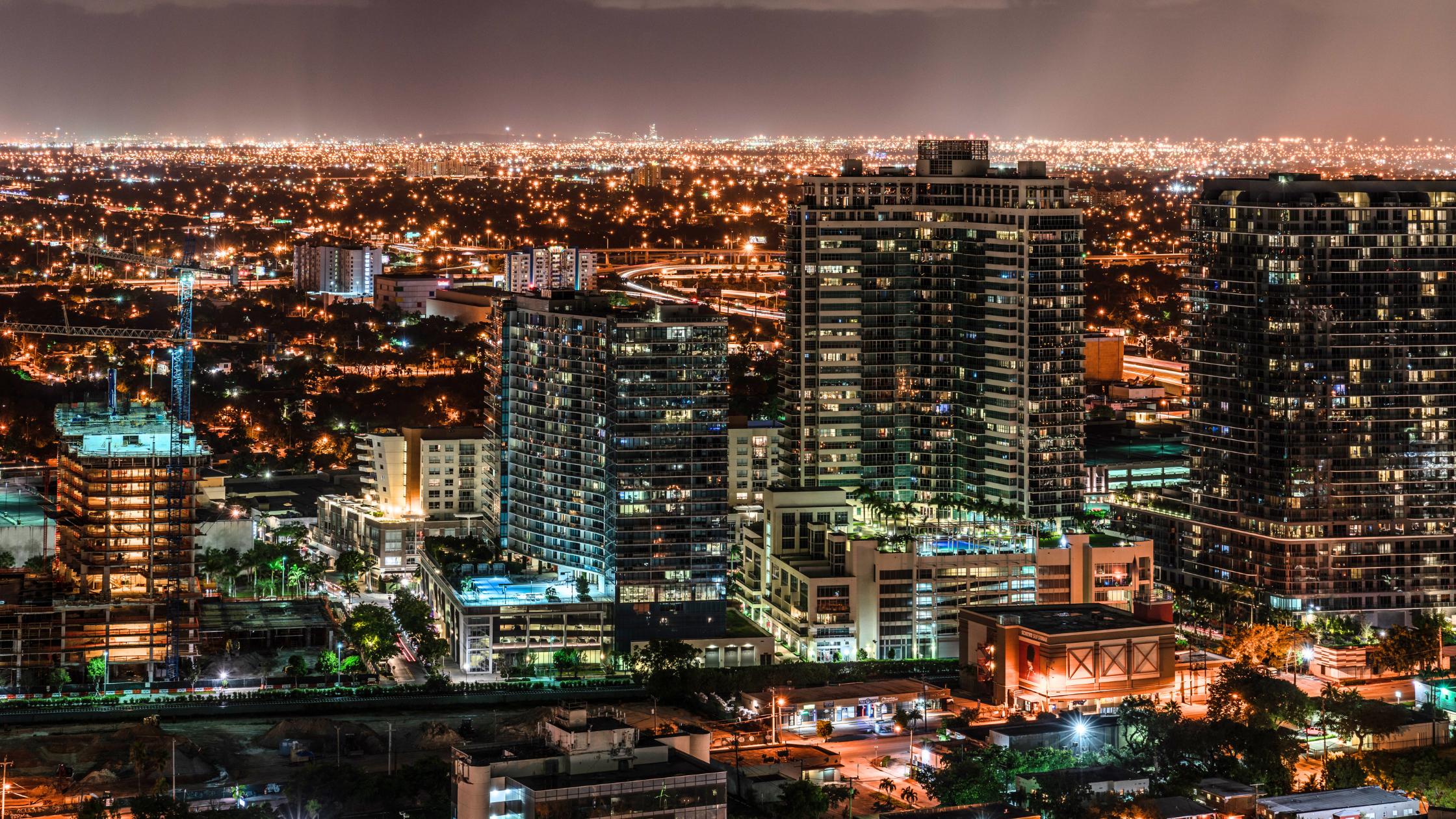 Midtown Miami skyline at dusk with mid-rise condos and Wynwood in the foreground