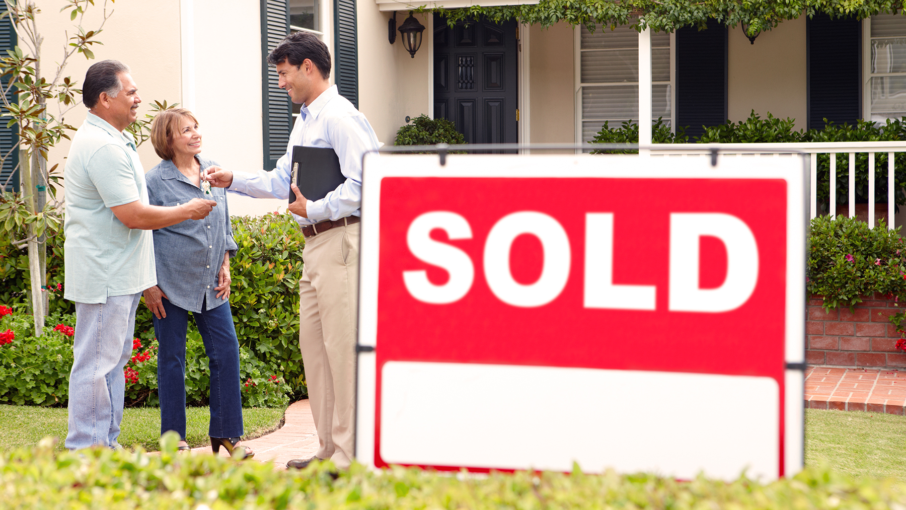 Senior Hispanic couple buying new home