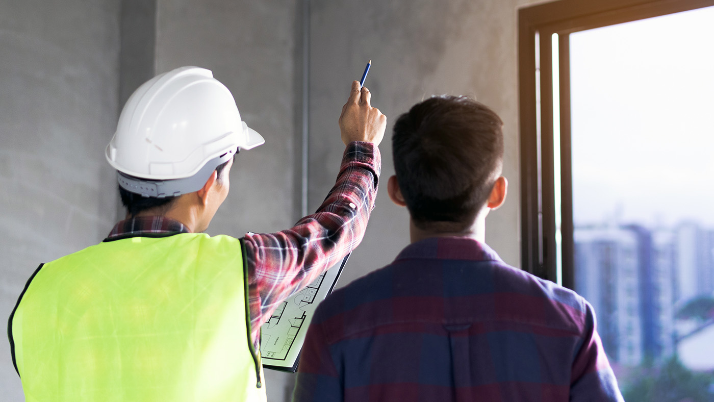 Client and Contractor discussing plan to renovation house.