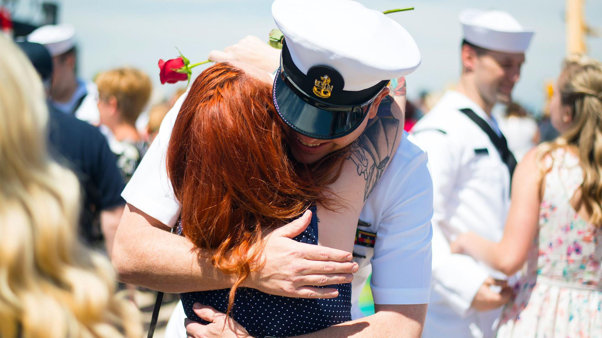 Navy officer hugging women