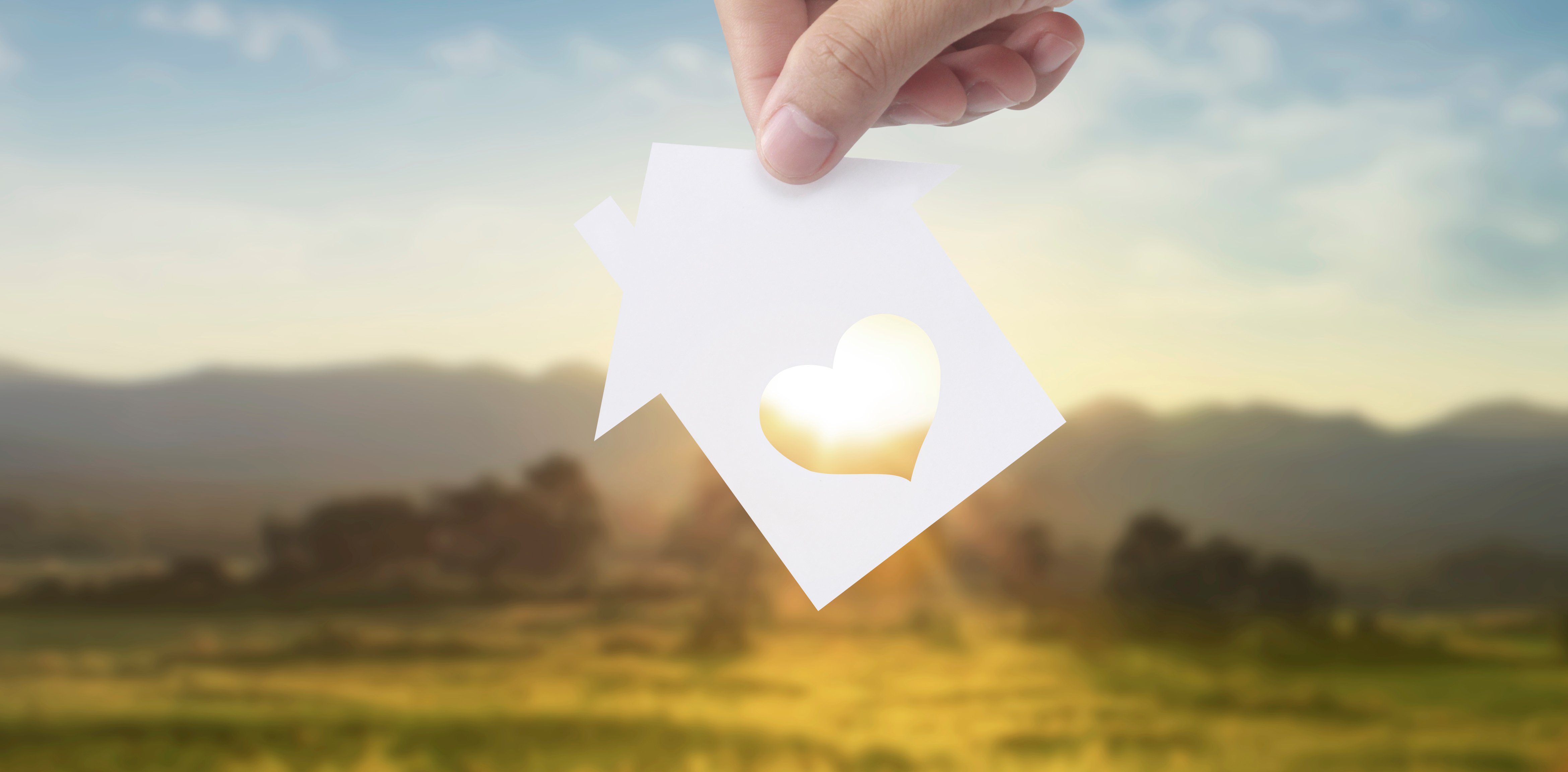 Hands holding paper house, family home  protecting insurance con