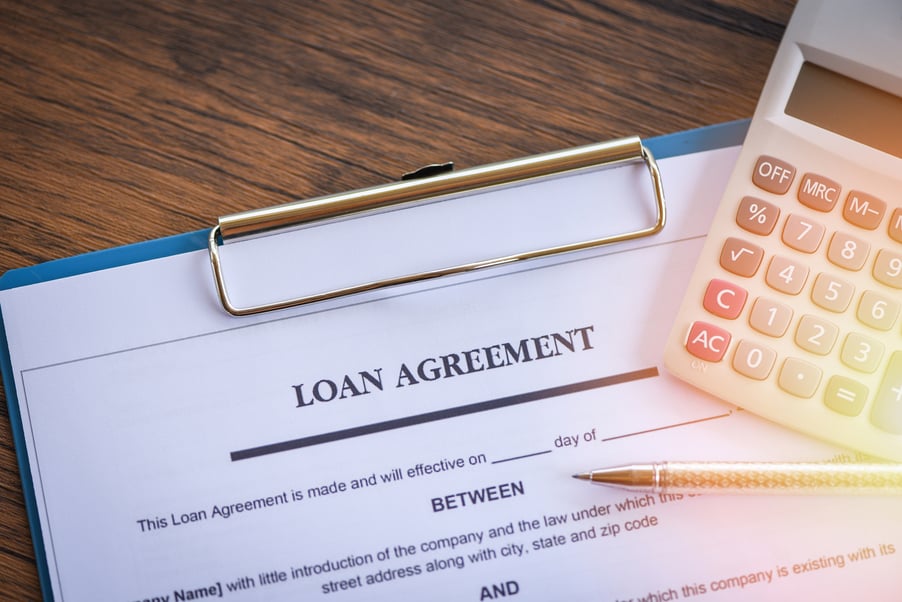 Loan application form with pen and calculator on paper financial