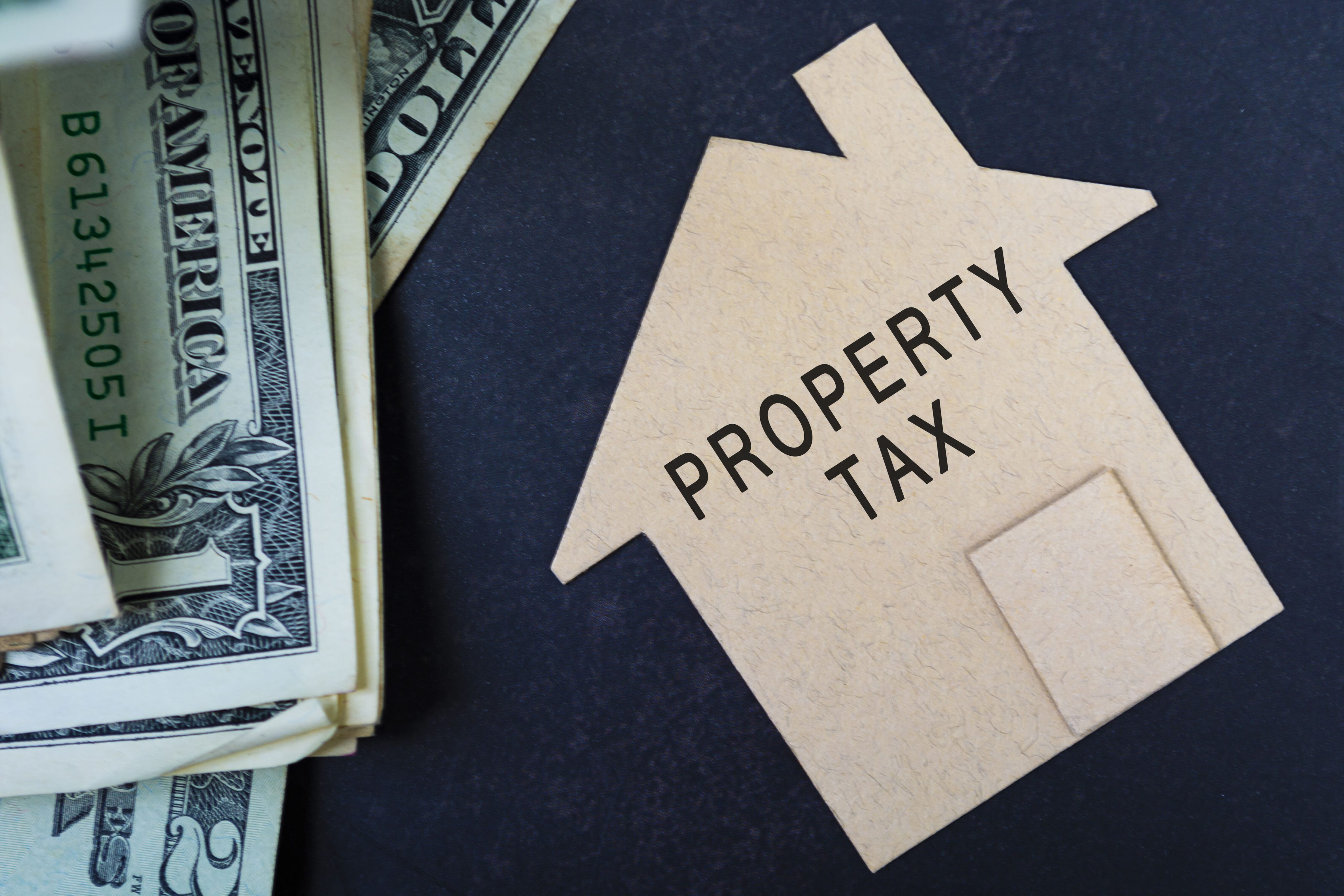 vecteezy_property-tax-text-on-brown-paper-house-model-with-dollar_7315846_optimized_4000