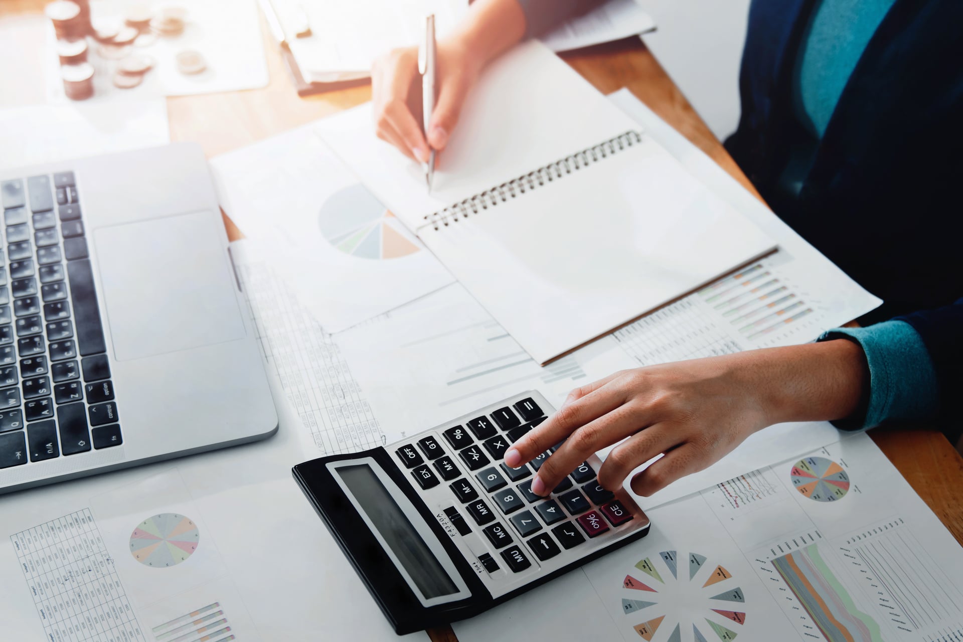 businesswoman working in office with using a calculator to calcu