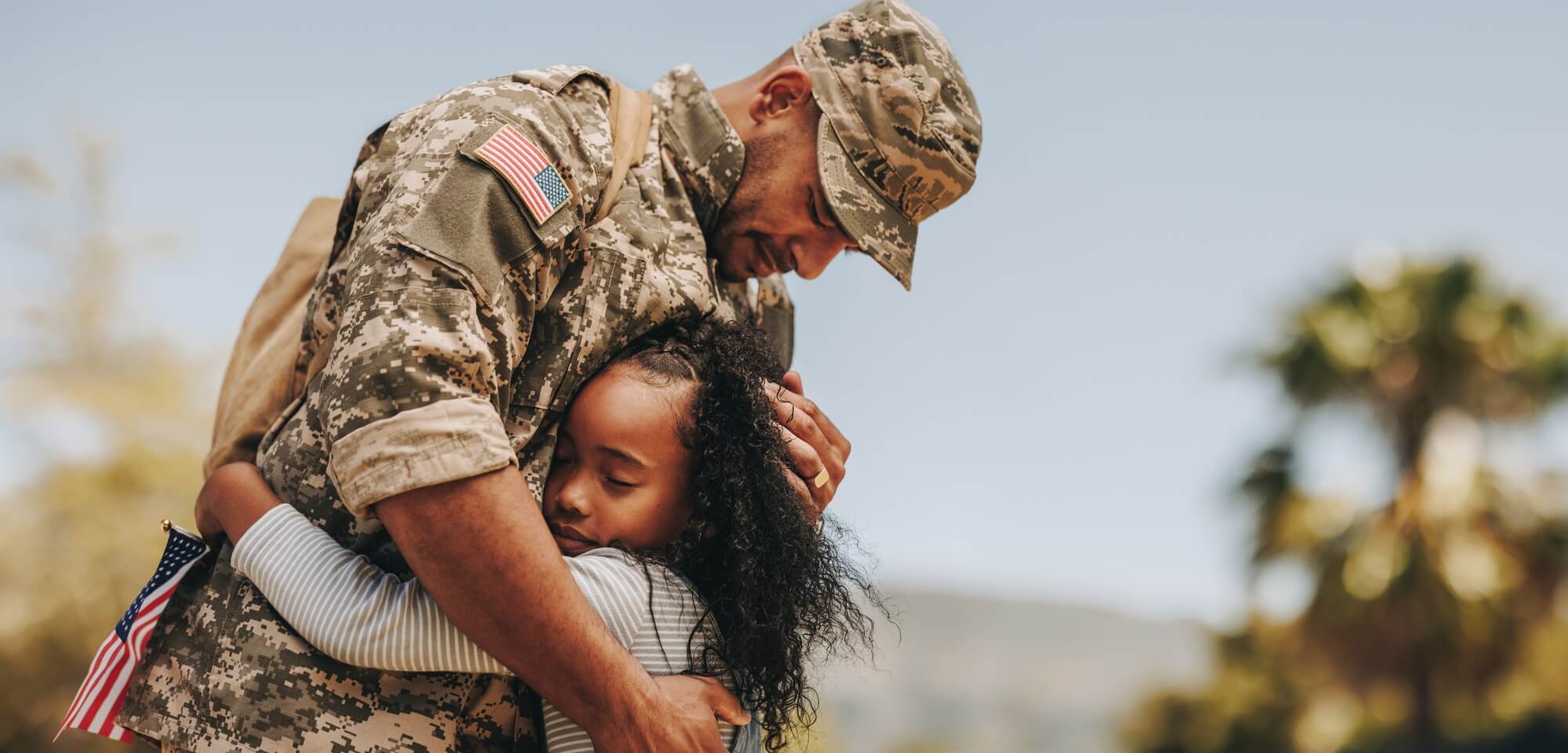 soldier hugging daughter