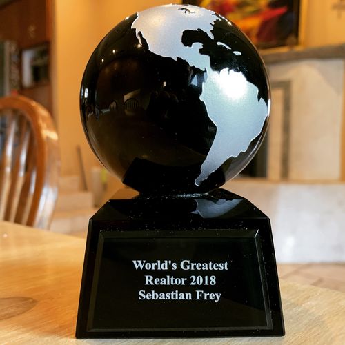 World's Greatest Realtor 2018 award, a glass globe on a black base engraved for Sebastian Frey