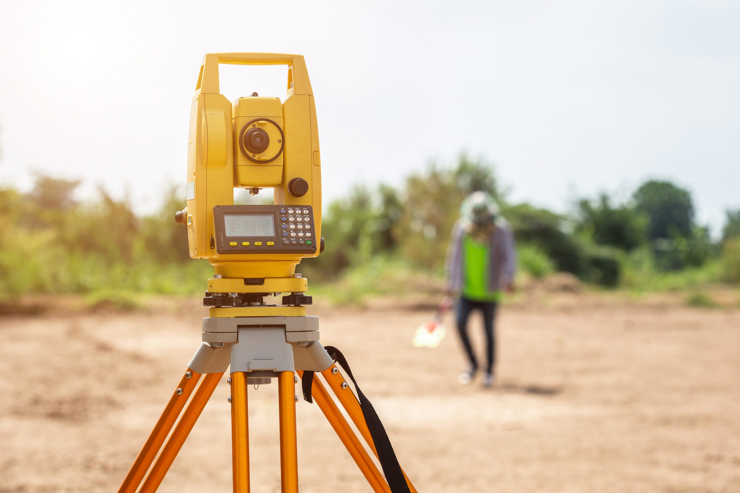 Surveyor engineer making measure at the land