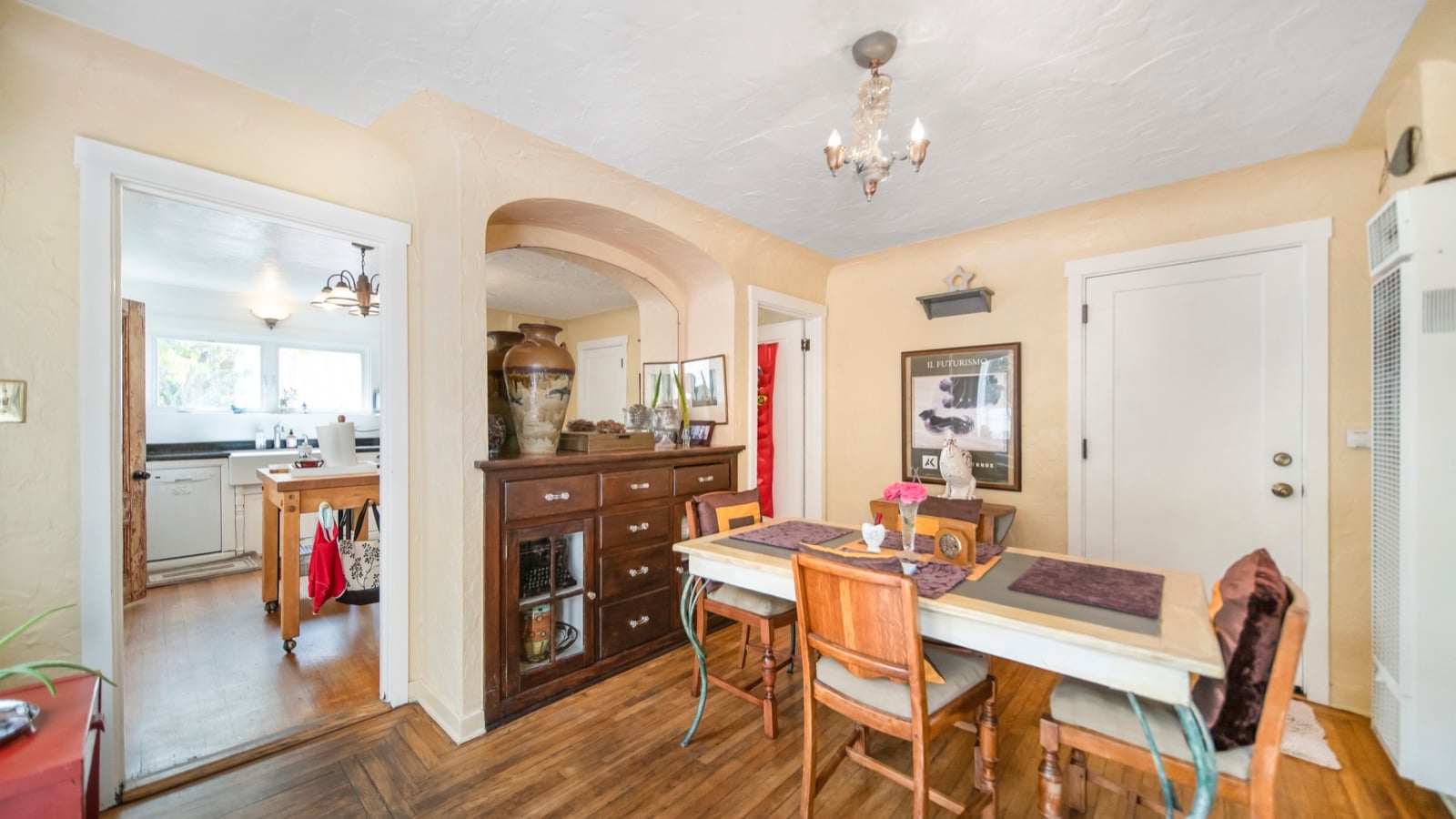 Dining room with original wood floors and French doors to the side patio