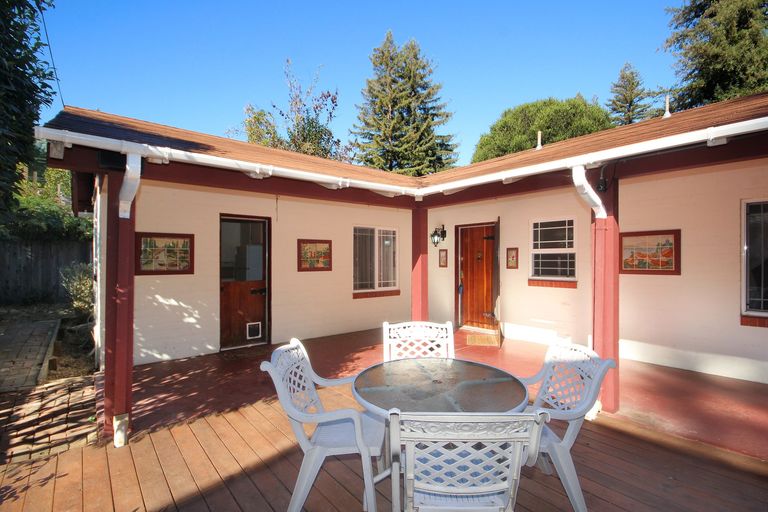 Wood deck with a patio table and chairs, built over the septic tanks