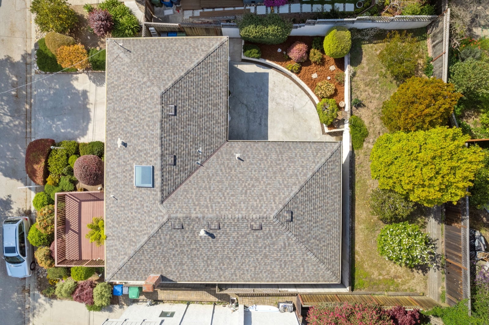 Drone view looking down on the roof, patio and gardens