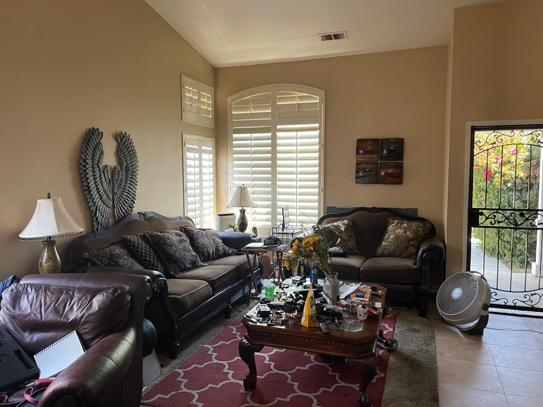 Living room before: crowded with sofas and clutter