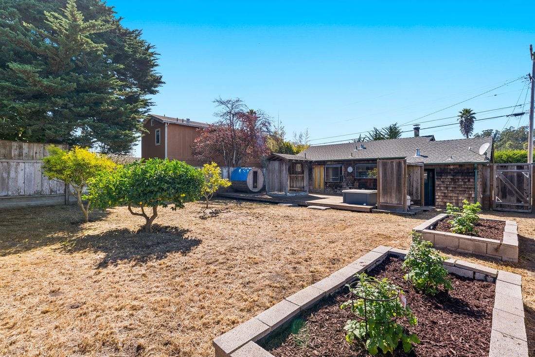 Backyard after: cleared yard with raised garden beds