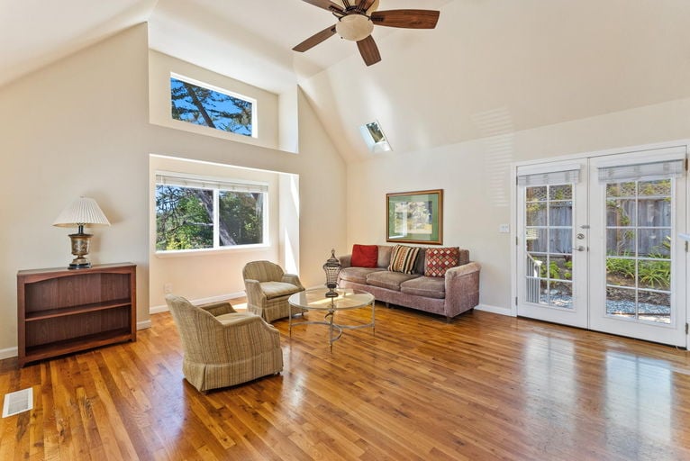 Vaulted living room with clerestory windows and oak floors