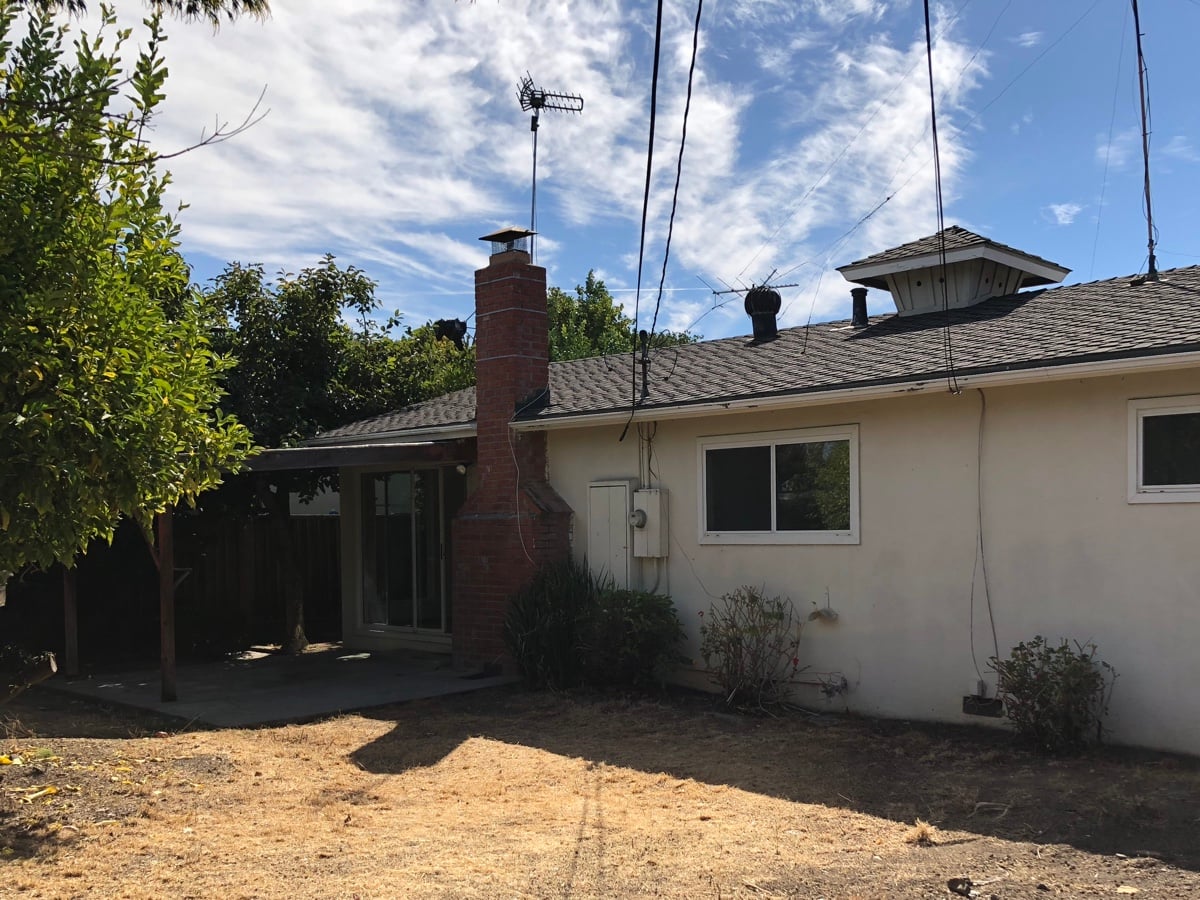 Backyard of the house after clean-up, showing the rear of the house and chimney