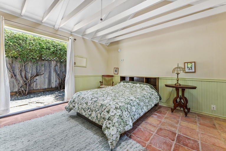Cottage interior with open beams and French doors