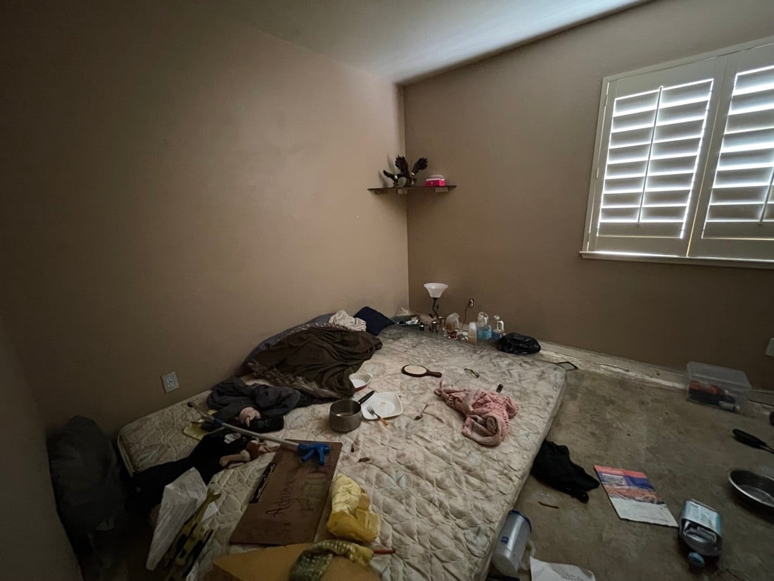 Bedroom before: floor covered in debris