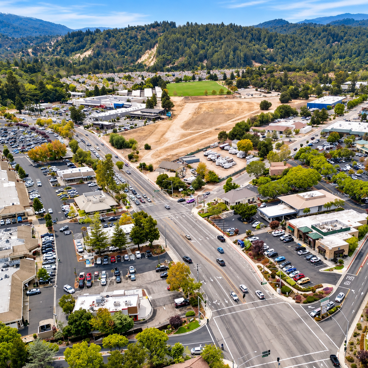 Aerial Suburban Intersection and Forested Hills