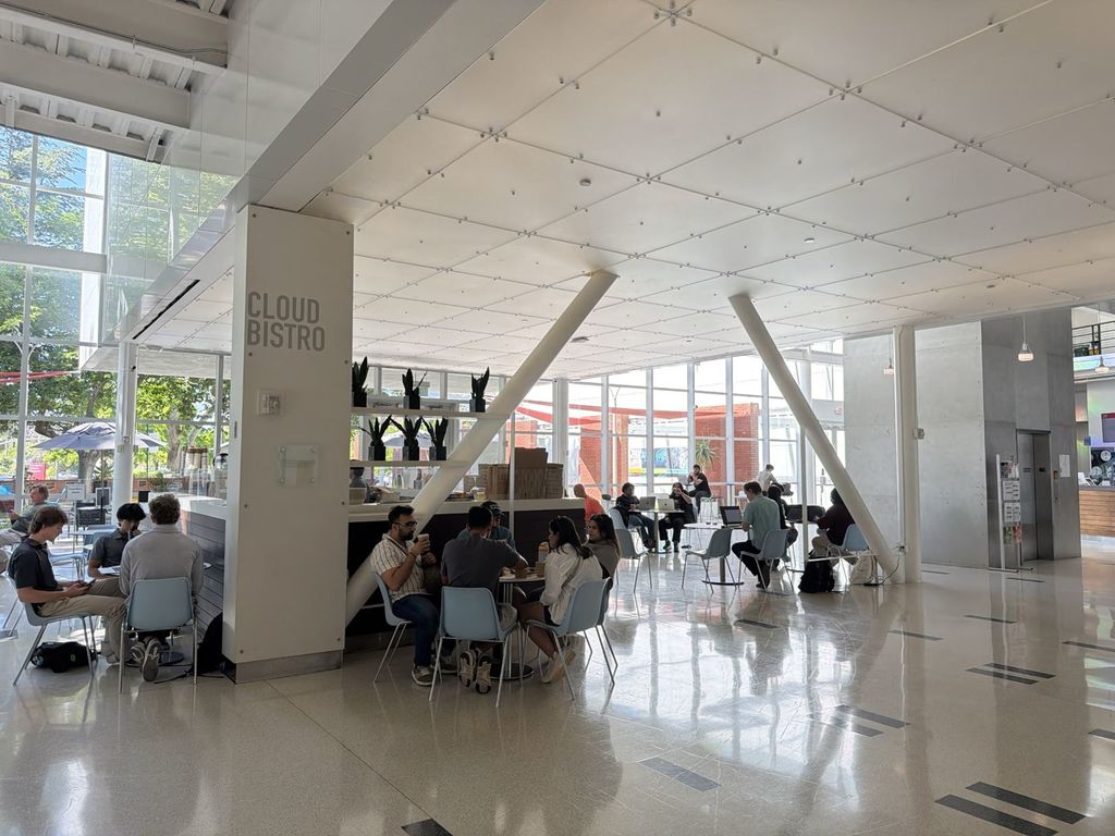 Cloud Bistro cafe inside the Computer History Museum lobby in Mountain View with visitors seated at tables and floor to ceiling windows
