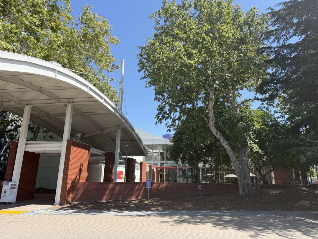 Exterior entrance of the Computer History Museum at 1401 N. Shoreline Blvd in Mountain View with red brick columns and curved canopy