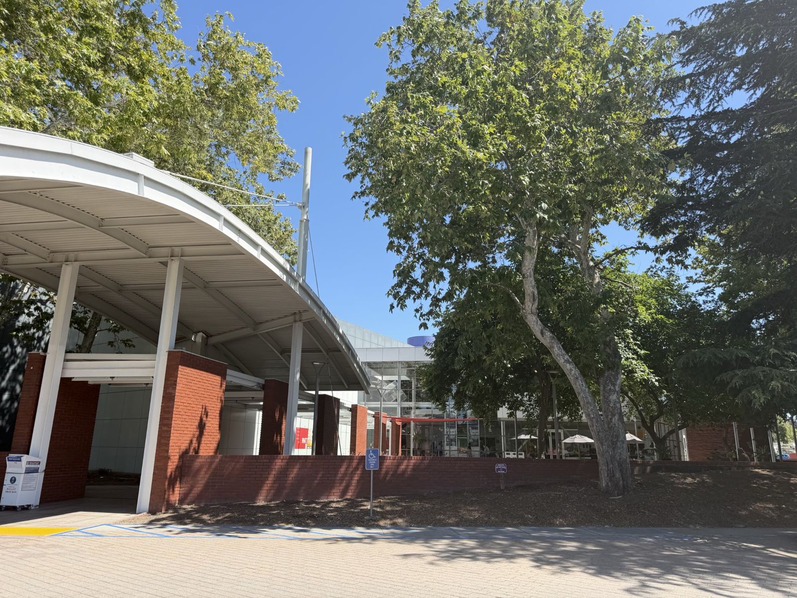 Exterior entrance of the Computer History Museum at 1401 N. Shoreline Blvd in Mountain View with red brick columns and curved canopy
