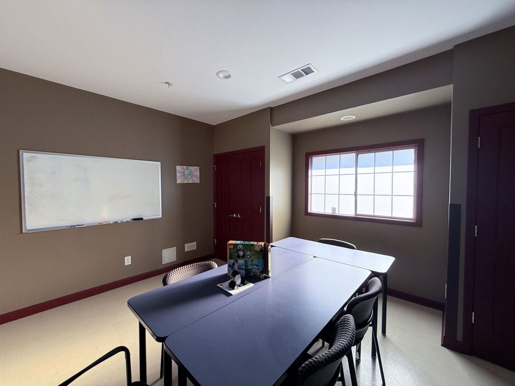 Quiet small group room with a whiteboard and a table set up for a building-block project at Hearts & Minds Activity Center in San Jose