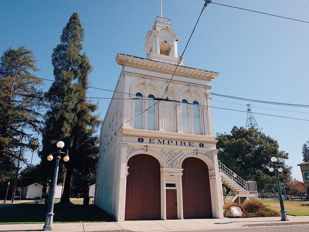 Empire Firehouse replica with bell tower and red doors at History Park San Jose