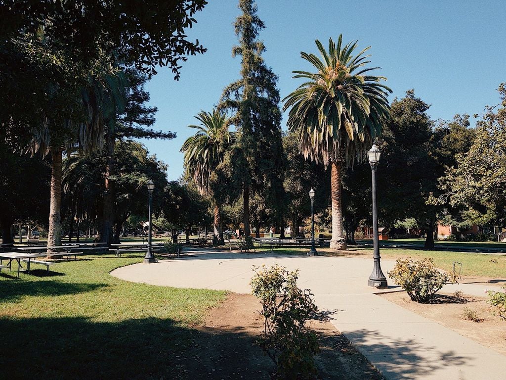 Shaded lawn, picnic tables, and paved paths at History Park San Jose