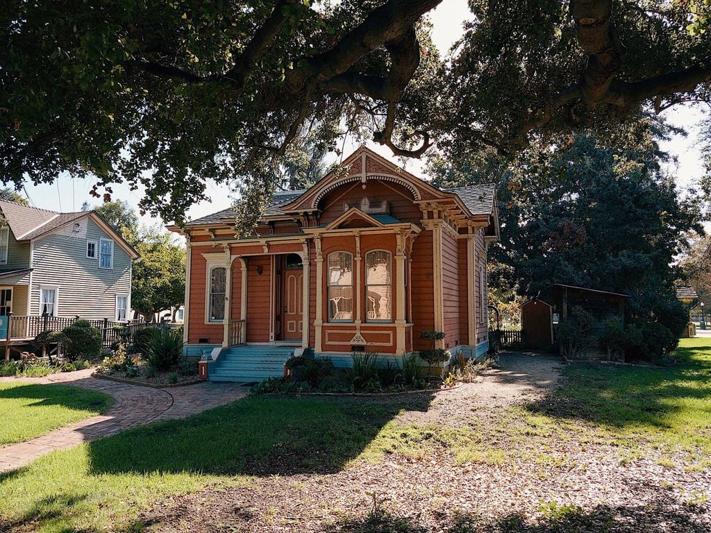 Ornate Italianate Victorian cottage under a heritage oak at History Park San Jose