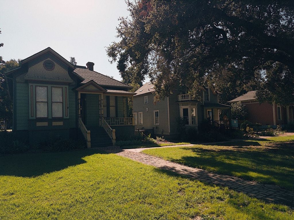 Row of restored Victorian homes along a brick path at History Park San Jose