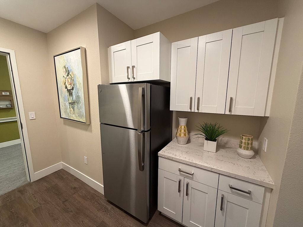 Apartment kitchenette with refrigerator and quartz counter at Ivy Park at San Tomas
