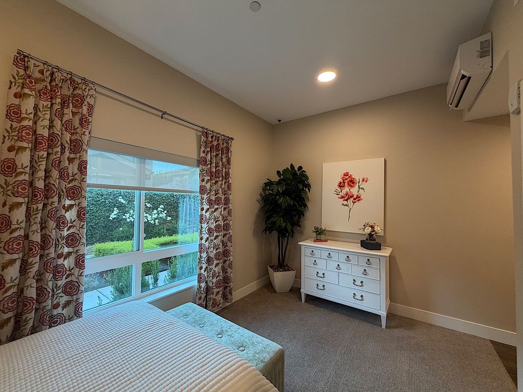 Model studio with garden-view window, dresser and wall AC unit at Ivy Park at San Tomas
