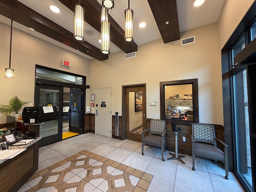 Ground floor lobby with pendant lights and wood beams at Villa Toscana Memory Care, 939 W El Camino Real, Mountain View