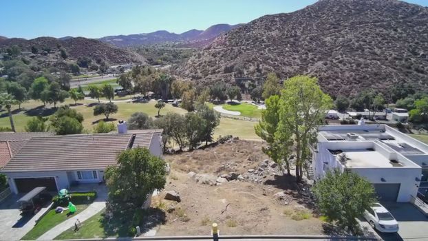 30789 Early Round Drive, Canyon Lake CA - aerial view of the lot with the mountains behind the course