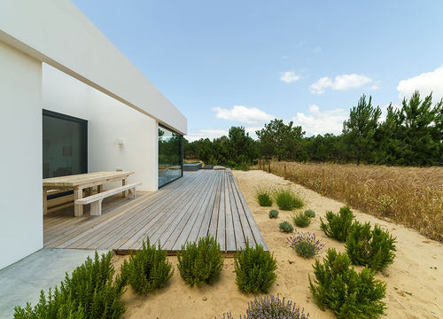 Modern house with garden swimming pool and wooden deck