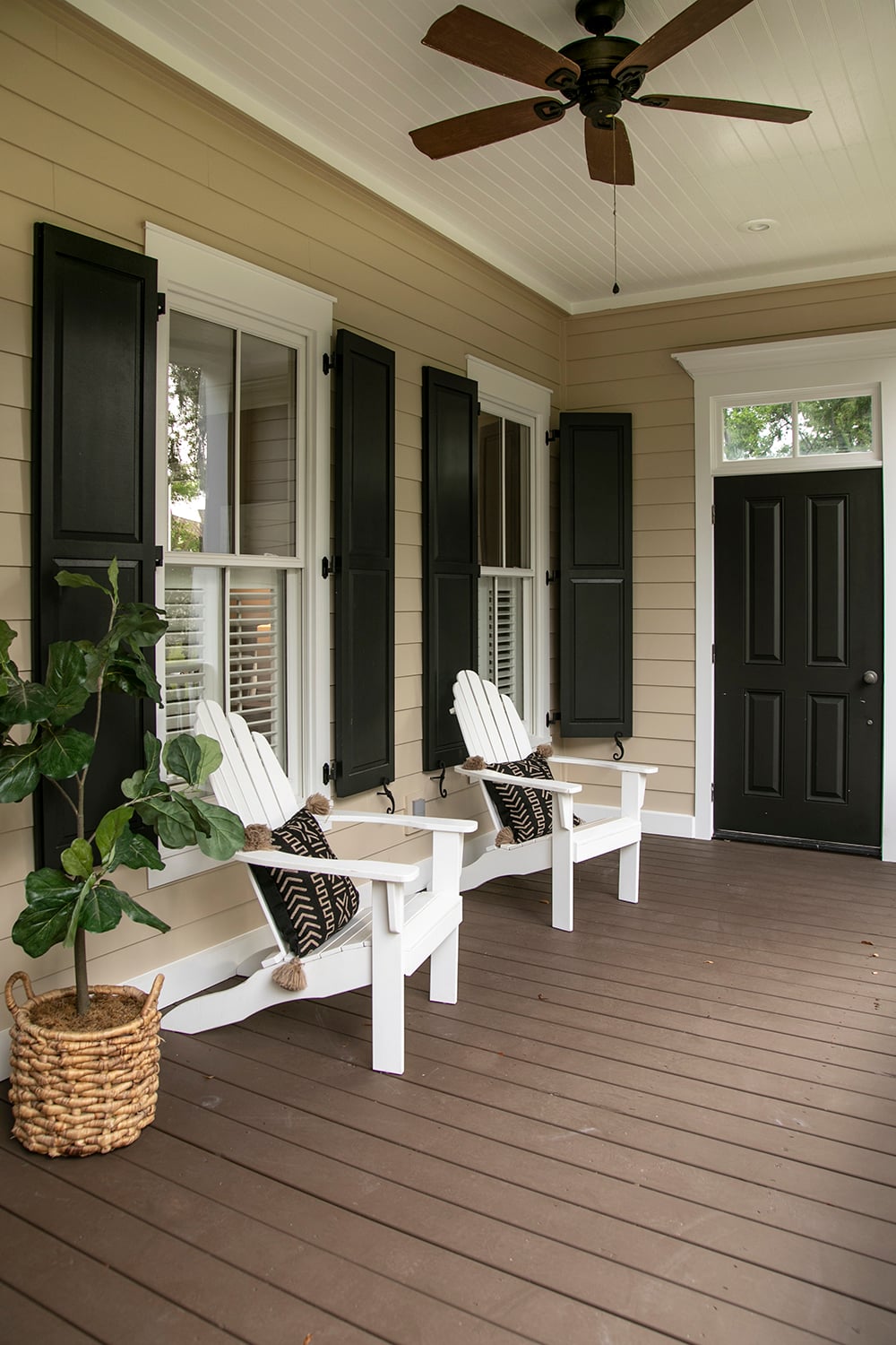 Charleston style porch with chairs and entry door on southern ho