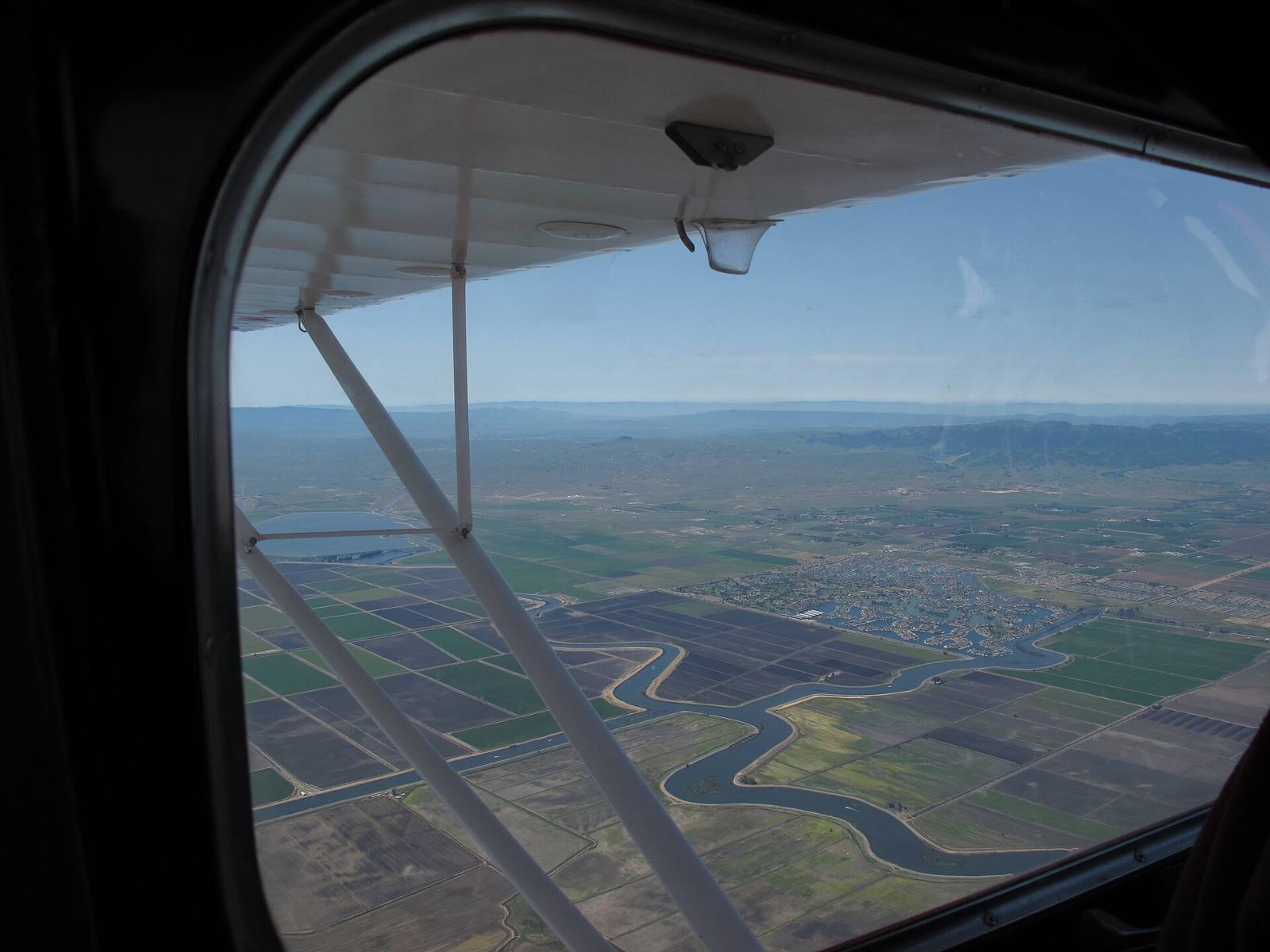 Aerial view of Delta channels and farm fields with Discovery Bay, California in the distance, seen from a small plane, April 2012
