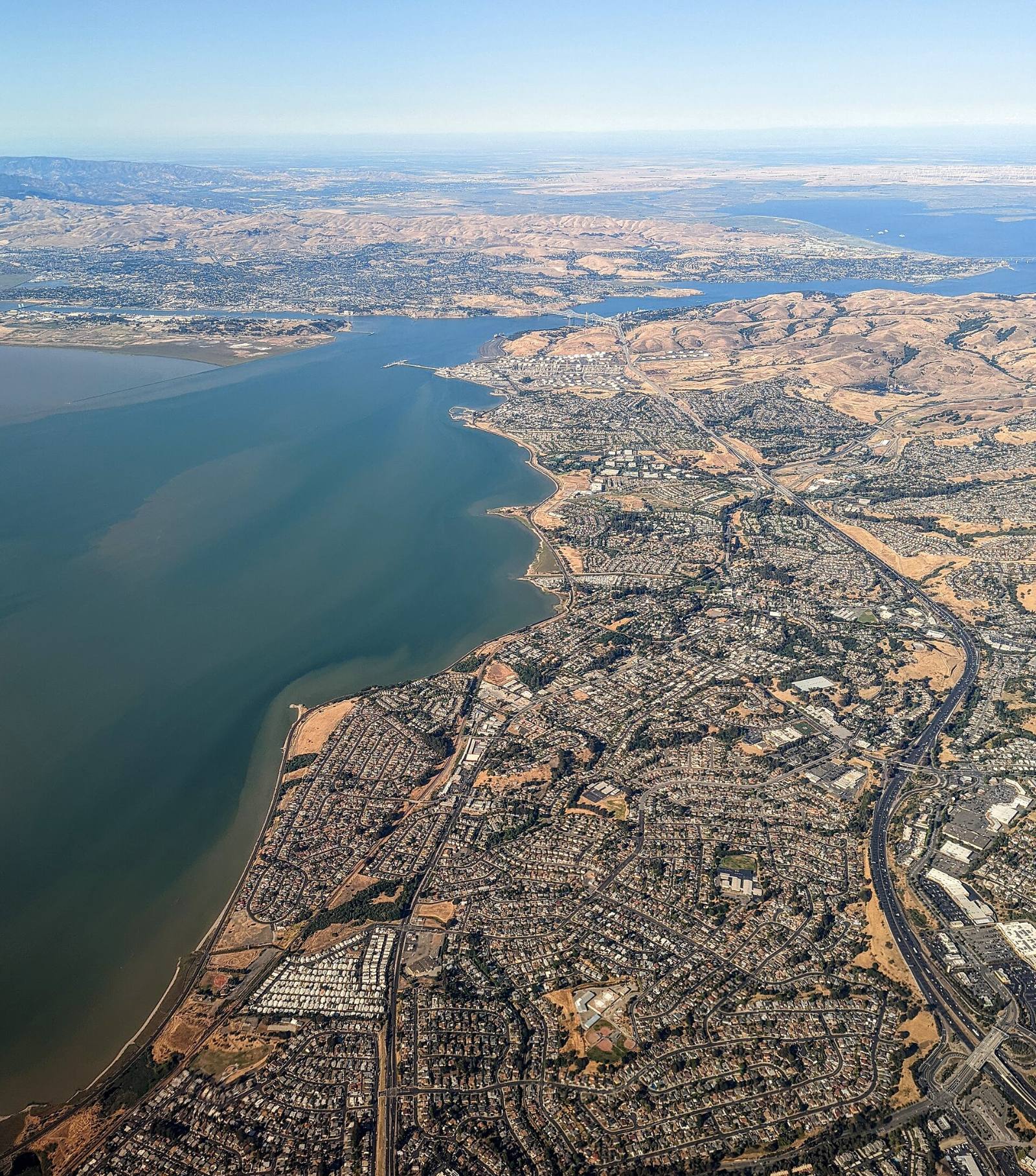 Aerial view of Pinole, California, with I-80 and the bay shoreline, 2022