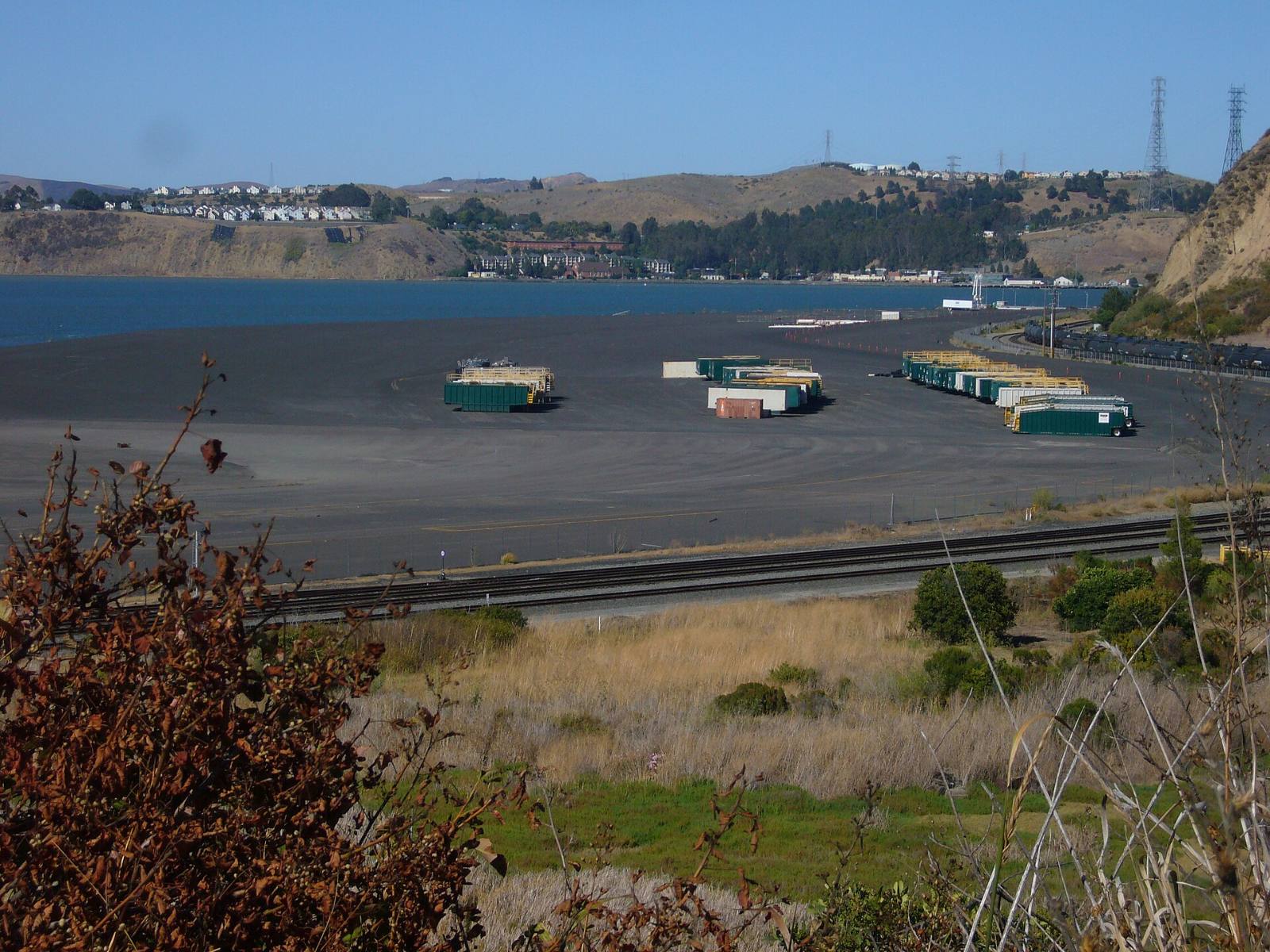 Low shoreline flats with a rail line along San Pablo Bay at the edge of Rodeo, California, with hillside homes behind, 2007