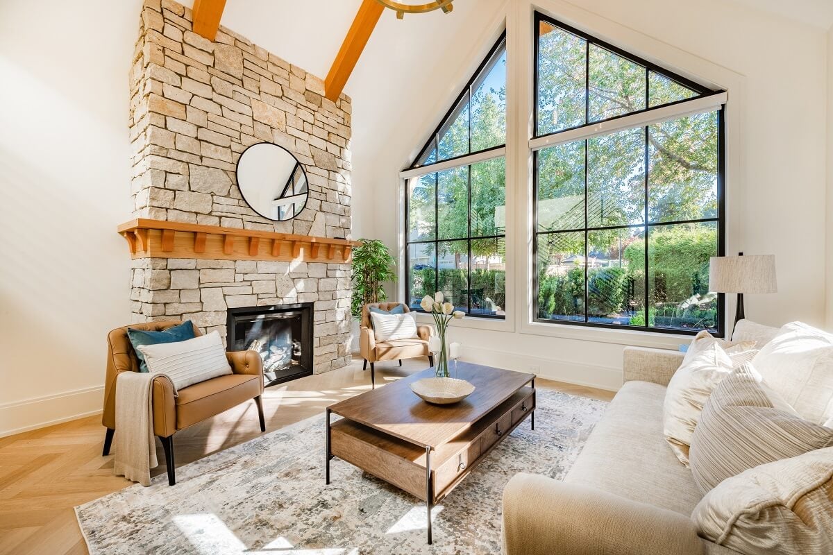 Open concept living room with fireplace wooden beams